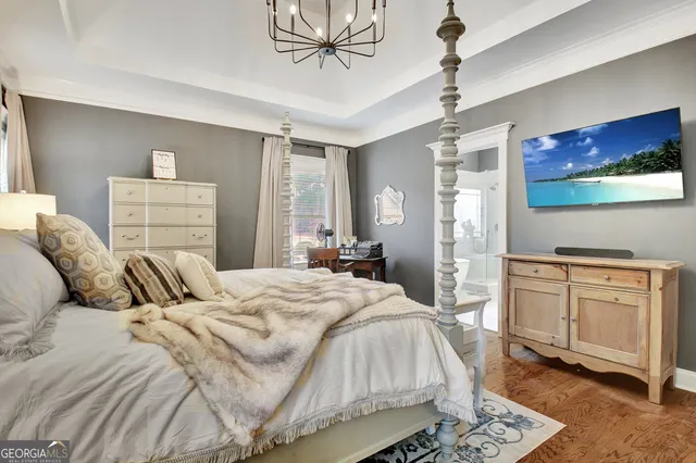 a spacious bedroom with a bed a table and chair