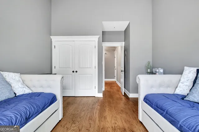 a bedroom with a bed and wooden floor