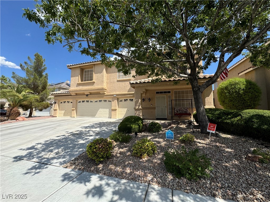 420 Rhythm Street Henderson, NV 89074 - Photo 1 of 27 View of front of property with stucco siding, a tile roof, driveway, a garage, and a porch