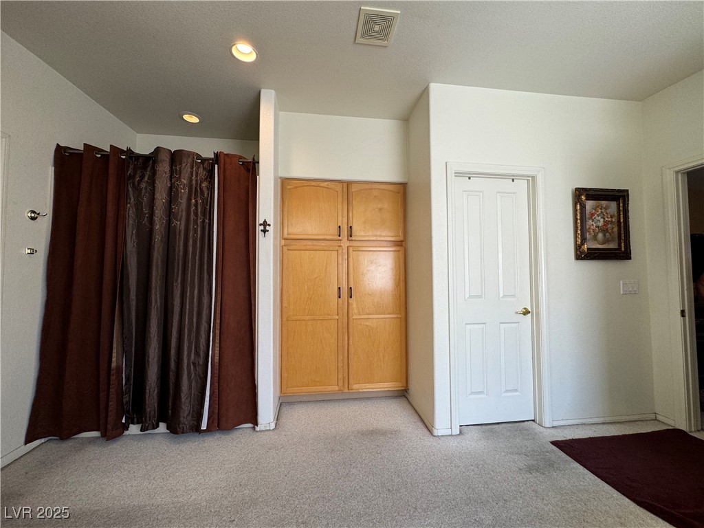 420 Rhythm Street Henderson, NV 89074 - Photo 13 of 27 Unfurnished bedroom featuring light carpet and recessed lighting