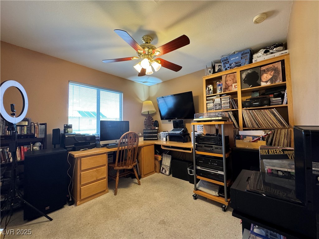 420 Rhythm Street Henderson, NV 89074 - Photo 14 of 27 Office area with light carpet and a ceiling fan