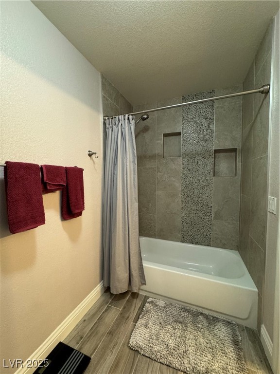 420 Rhythm Street Henderson, NV 89074 - Photo 16 of 27 Bathroom featuring shower / bathtub combination with curtain, wood finished floors, and a textured ceiling