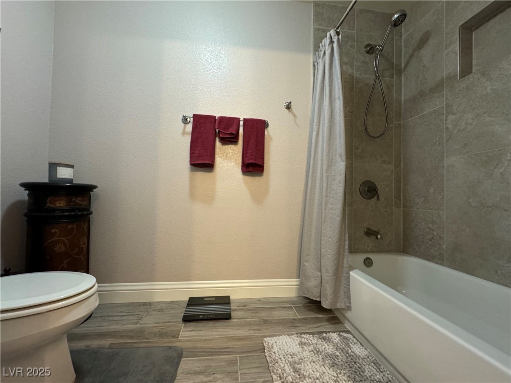 420 Rhythm Street Henderson, NV 89074 - Photo 17 of 27 Full bathroom with shower / bath combo with shower curtain and wood tiled floors