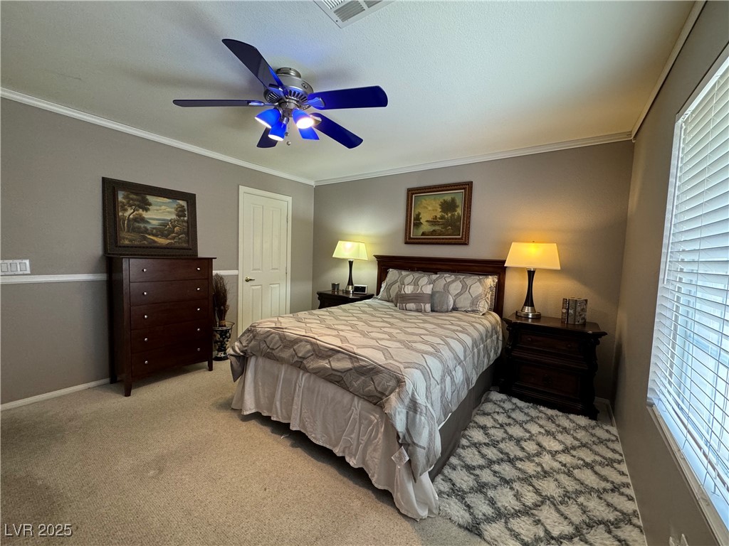 420 Rhythm Street Henderson, NV 89074 - Photo 20 of 27 Carpeted bedroom with ornamental molding and a ceiling fan