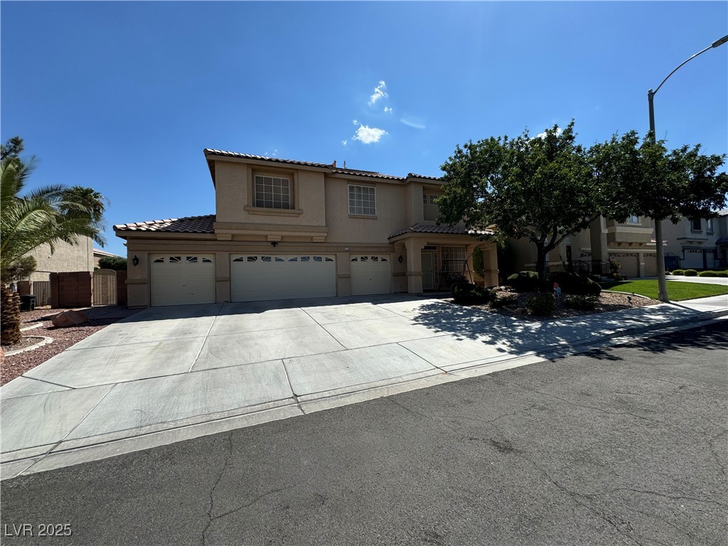 420 Rhythm Street Henderson, NV 89074 - Photo 2 of 27 View of front of home featuring concrete driveway, stucco siding, a garage, and a tiled roof