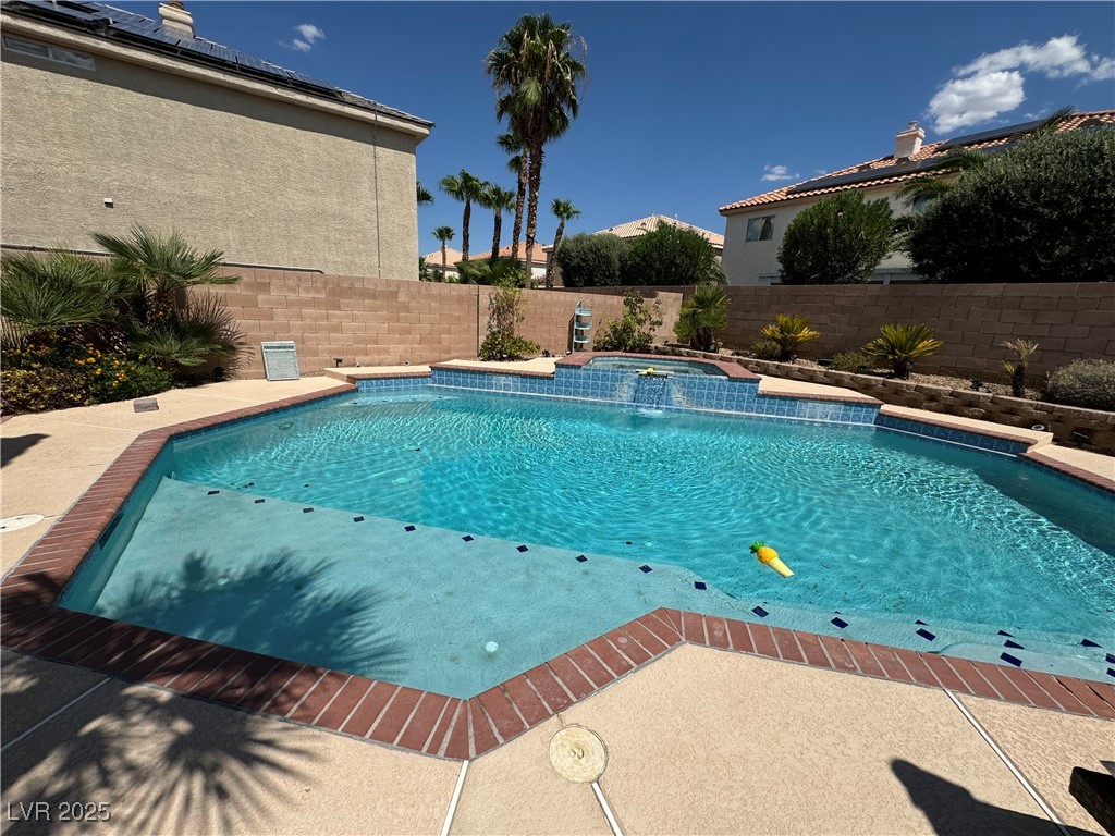 420 Rhythm Street Henderson, NV 89074 - Photo 23 of 27 View of swimming pool with a patio, a fenced backyard, and a pool with connected hot tub