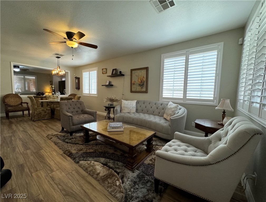 420 Rhythm Street Henderson, NV 89074 - Photo 4 of 27 Living room featuring a textured ceiling, wood finished floors, and ceiling fan
