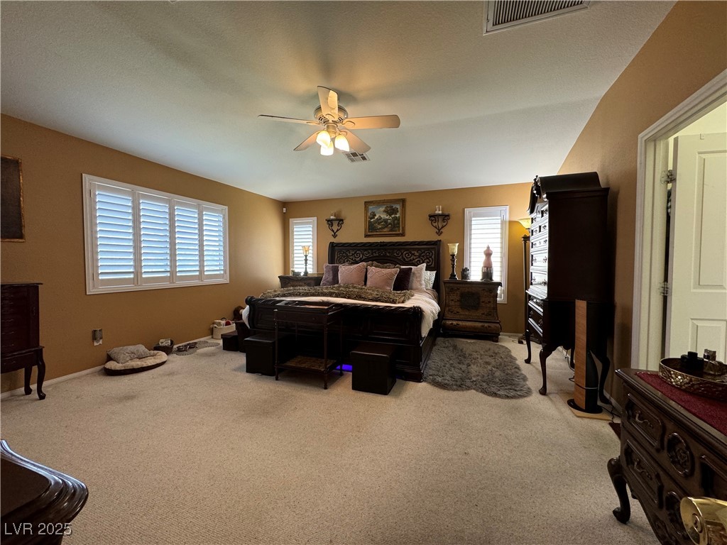 420 Rhythm Street Henderson, NV 89074 - Photo 10 of 27 Bedroom featuring light carpet and ceiling fan