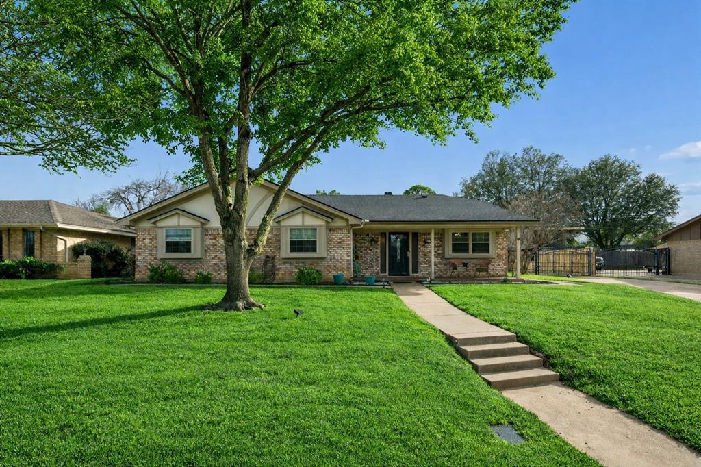 413 Baker Drive Hurst, TX 76054 - Photo 1 of 1 a front view of a house with a garden