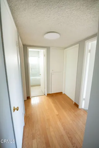 an empty room with wooden floor and door