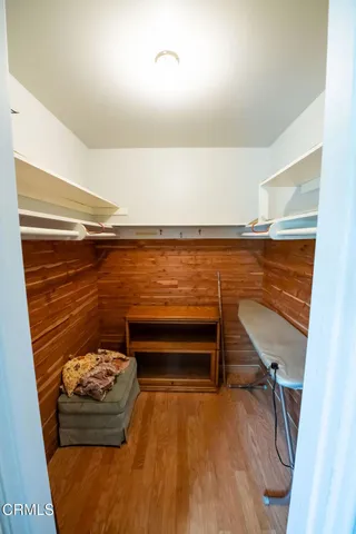 a view of water heater room with wooden floor
