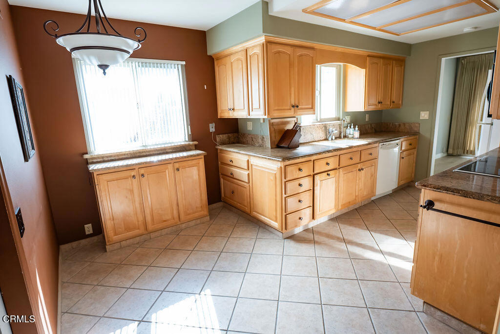 691 Springfield Avenue Ventura, CA 93004 - Photo 19 of 30 a kitchen with stainless steel appliances granite countertop a stove a sink and a refrigerator