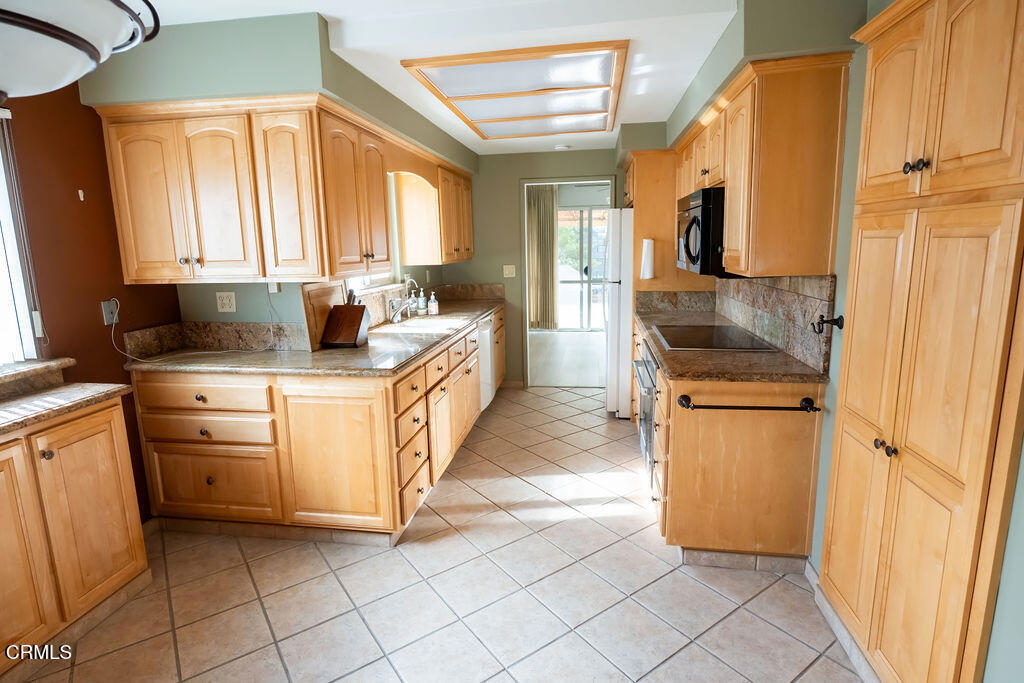 691 Springfield Avenue Ventura, CA 93004 - Photo 20 of 30 a kitchen with cabinets and window