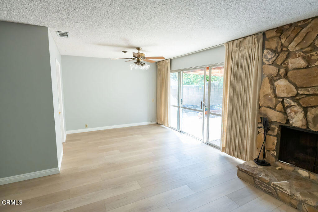 691 Springfield Avenue Ventura, CA 93004 - Photo 22 of 30 a view of an empty room with a fireplace and a window