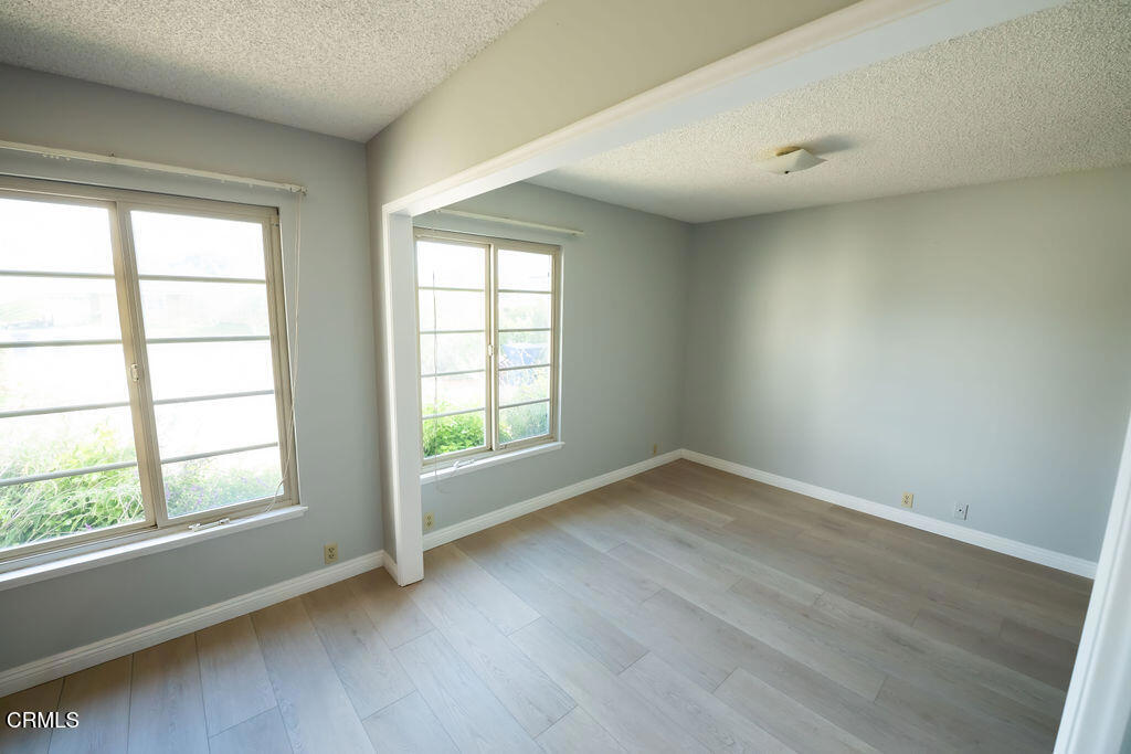 691 Springfield Avenue Ventura, CA 93004 - Photo 8 of 30 an empty room with wooden floor and windows