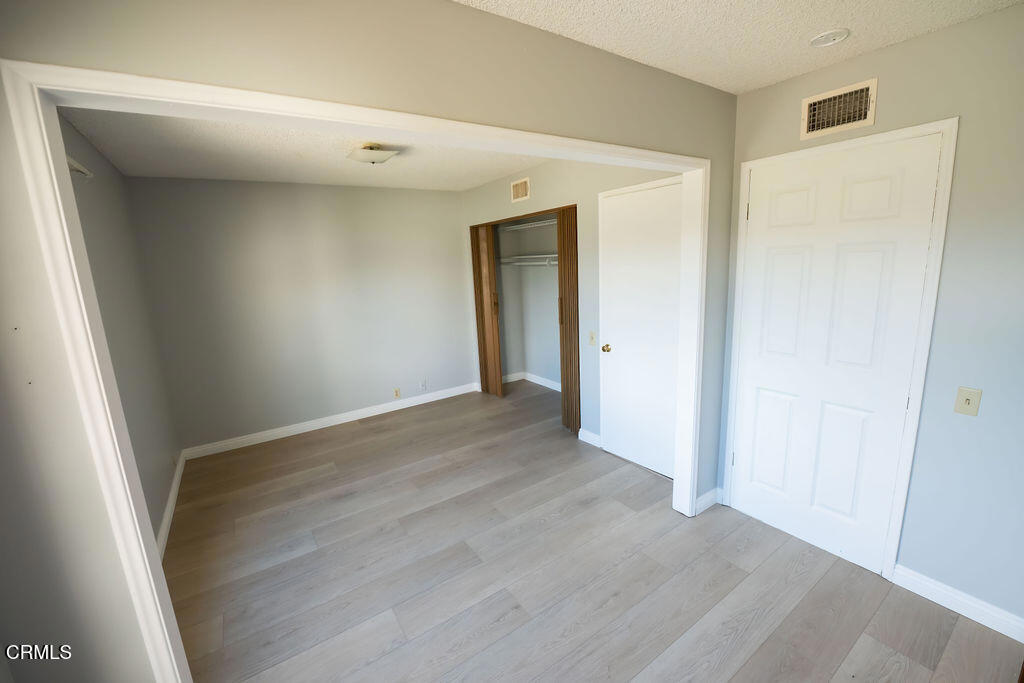 691 Springfield Avenue Ventura, CA 93004 - Photo 9 of 30 an empty room with wooden floor and windows