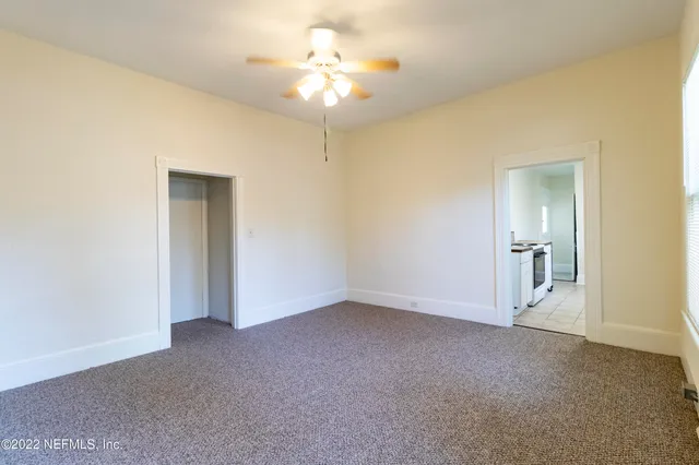 a view of empty room with a fan