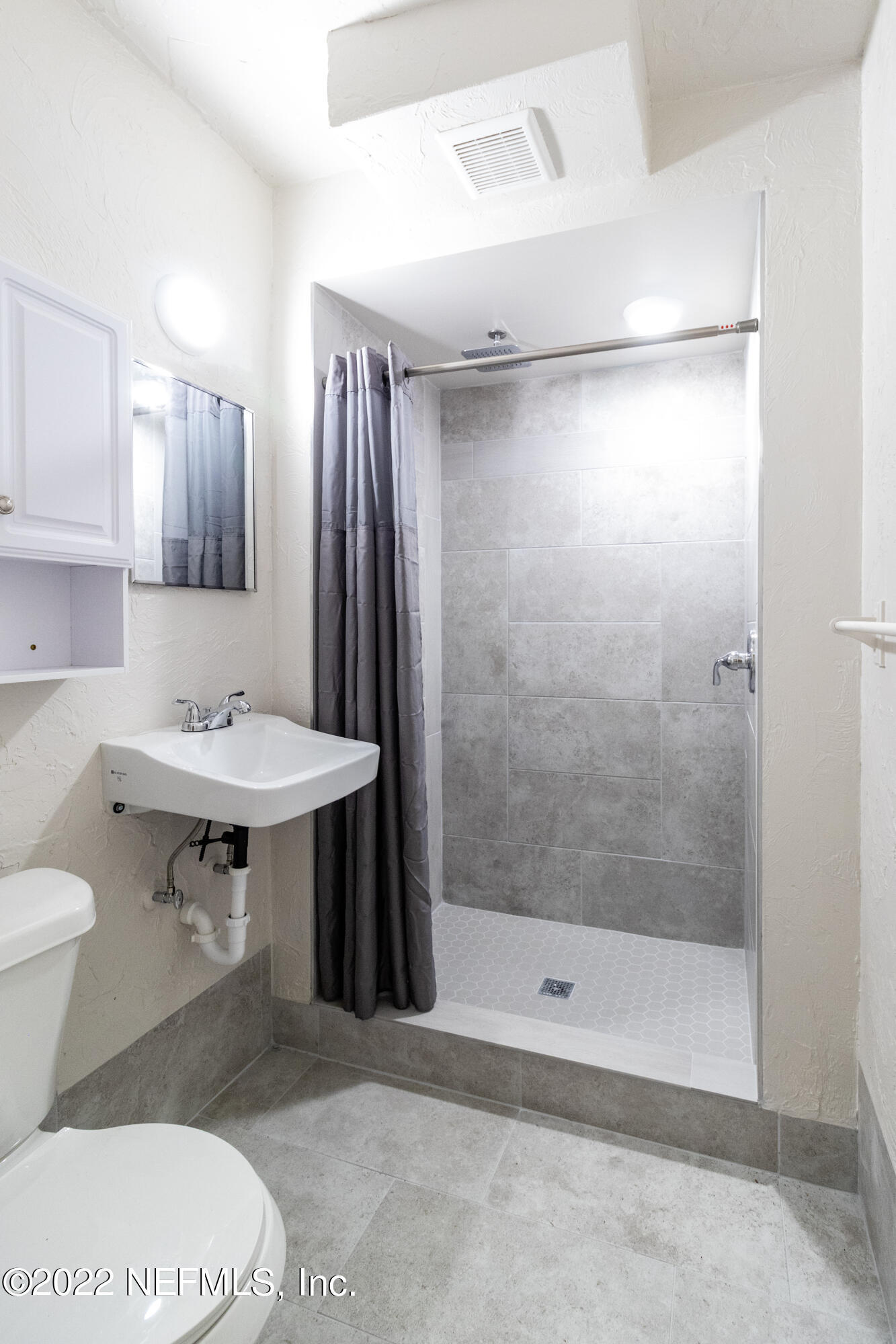 24 Riberia Street, Unit B St. Augustine, FL 32084 - Photo 17 of 19 a bathroom with a sink toilet and shower