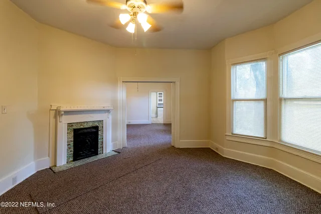 a view of an empty room with a window