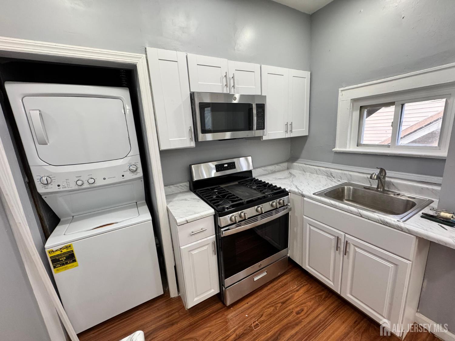 a kitchen with a stove microwave and sink