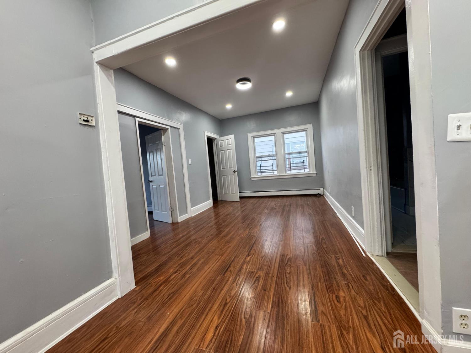 51 Poe Avenue, Unit 3 Newark, NJ 07106 - Photo 13 of 14 a view of hallway with wooden floor