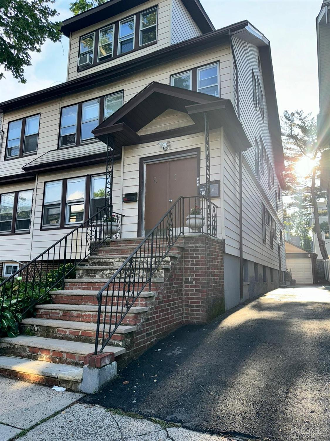 51 Poe Avenue, Unit 3 Newark, NJ 07106 - Photo 9 of 14 a front view of a house with garage