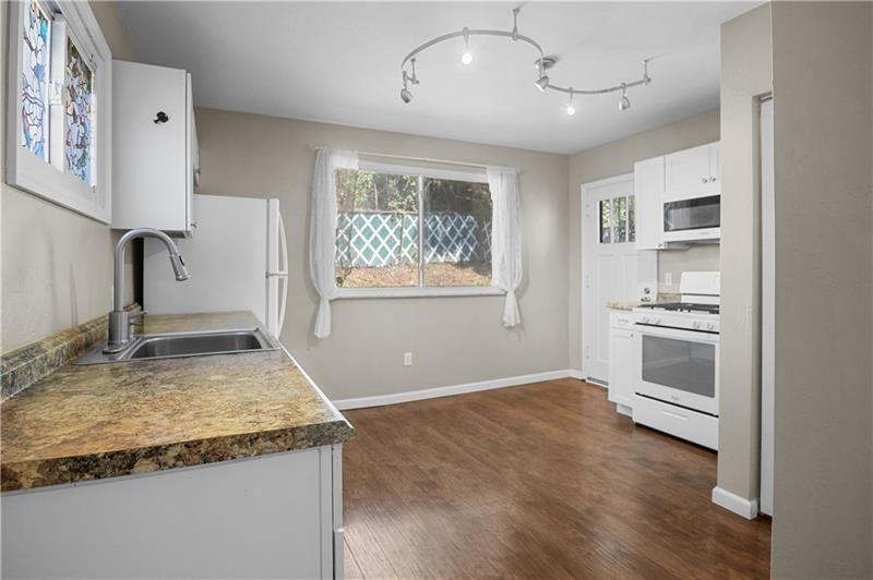 246 Dunseith Street Pittsburgh, PA 15213 - Photo 12 of 28 a kitchen with granite countertop a sink stainless steel appliances and cabinets