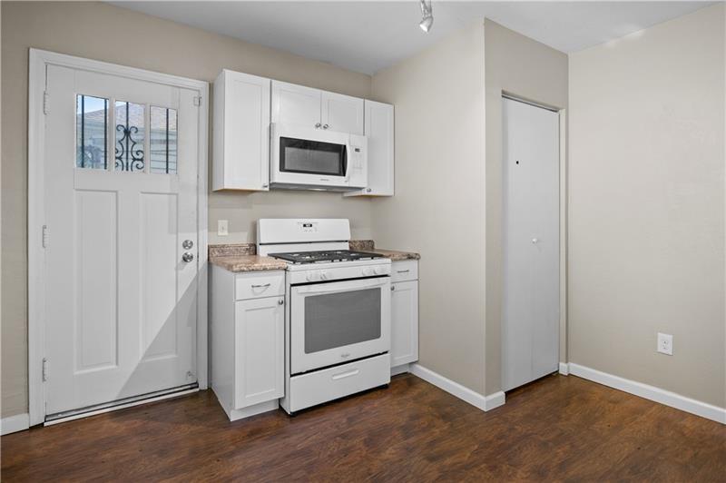 246 Dunseith Street Pittsburgh, PA 15213 - Photo 14 of 28 a kitchen with stainless steel appliances a stove microwave and sink
