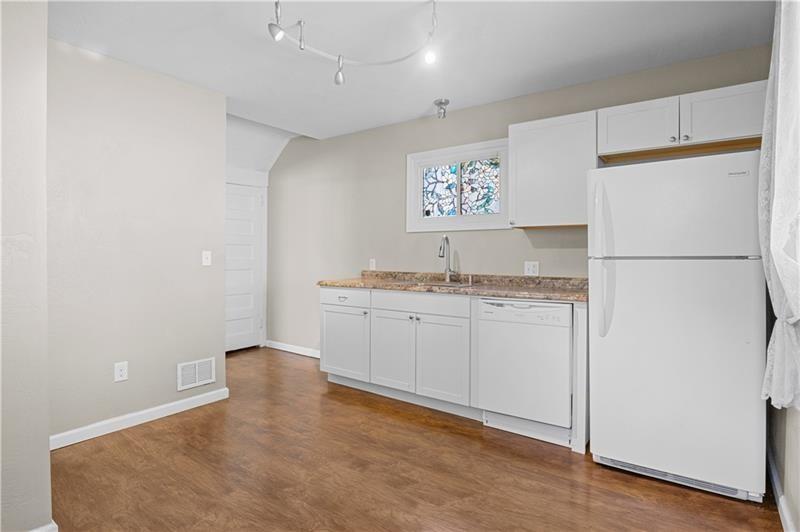 246 Dunseith Street Pittsburgh, PA 15213 - Photo 15 of 28 a kitchen with a refrigerator a stove a microwave and cabinets