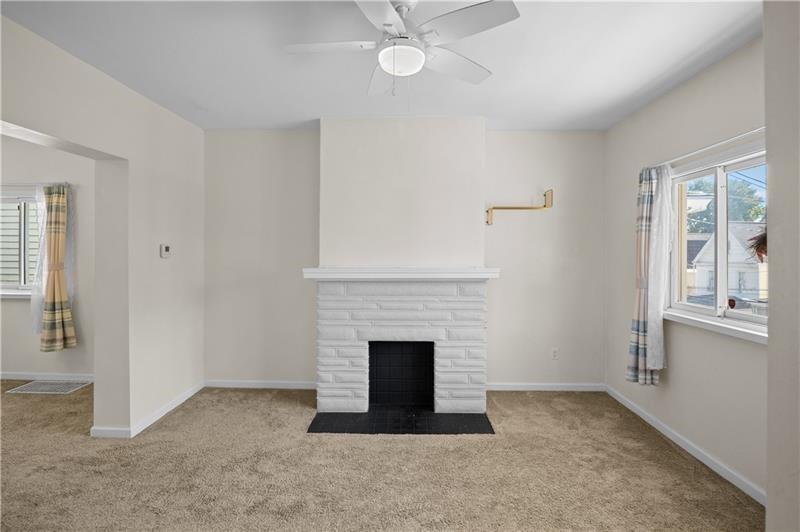246 Dunseith Street Pittsburgh, PA 15213 - Photo 8 of 28 an empty room with windows and fireplace