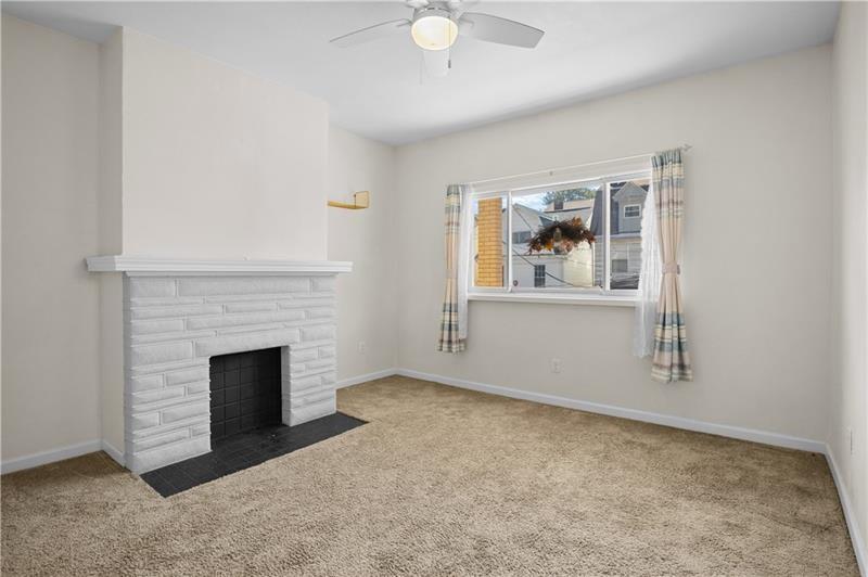 246 Dunseith Street Pittsburgh, PA 15213 - Photo 9 of 28 an empty room with fireplace and windows