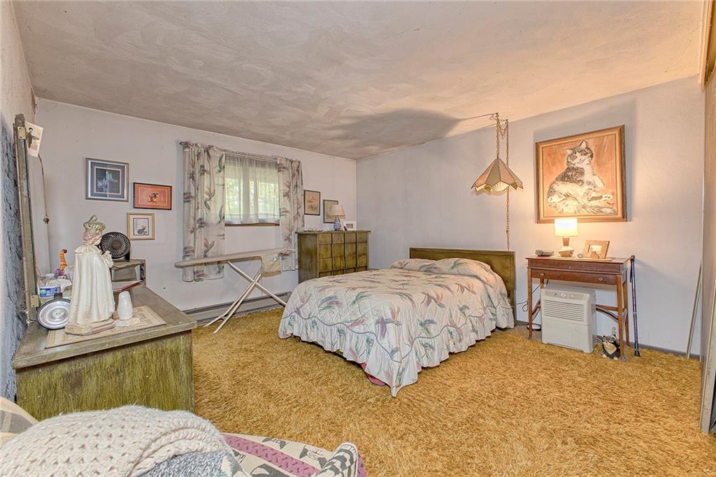 128 Raccoon Road, Unit ACME PA 15610 Acme, PA 15610 - Photo 12 of 23 a bedroom with a bed dresser and painting on the wall