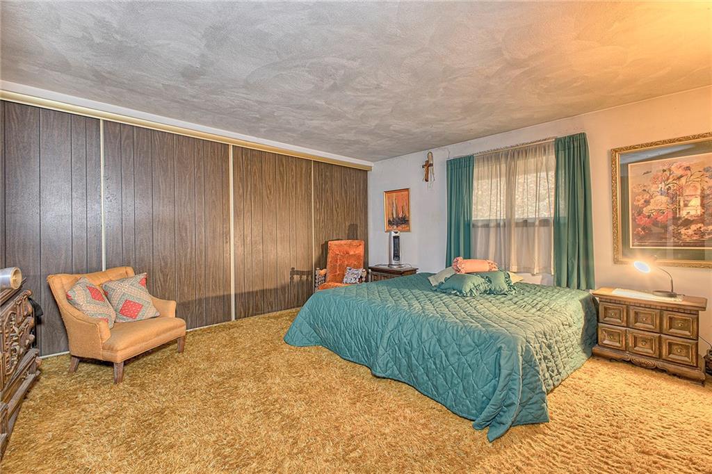 128 Raccoon Road, Unit ACME PA 15610 Acme, PA 15610 - Photo 14 of 23 a bedroom with a bed and dresser with mirror