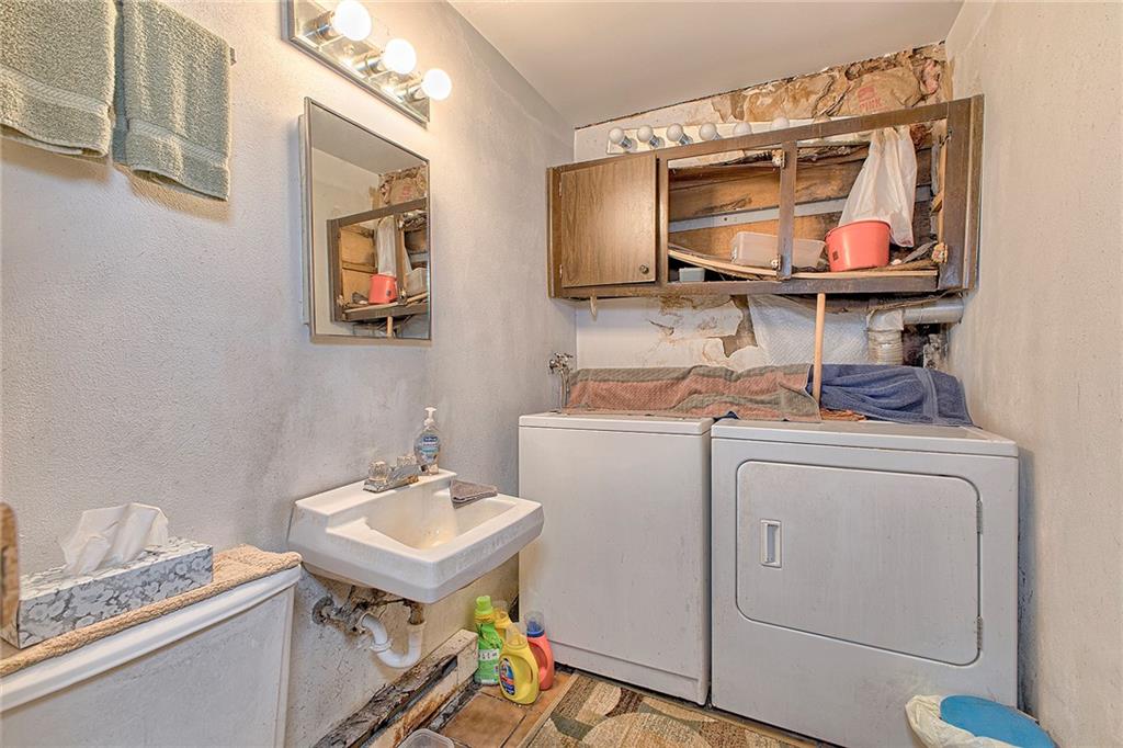 128 Raccoon Road, Unit ACME PA 15610 Acme, PA 15610 - Photo 18 of 23 a bathroom with a sink a toilet and a mirror