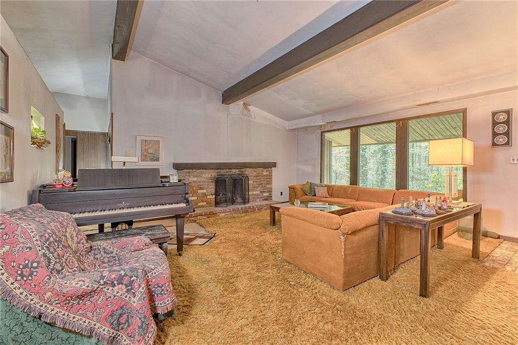 128 Raccoon Road, Unit ACME PA 15610 Acme, PA 15610 - Photo 2 of 23 a living room with furniture a fireplace and a table