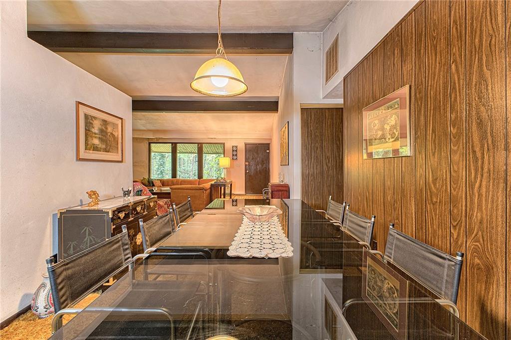 128 Raccoon Road, Unit ACME PA 15610 Acme, PA 15610 - Photo 6 of 23 a view of a dining room with furniture wooden floor and chandelier