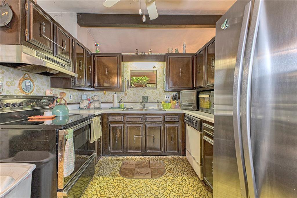 128 Raccoon Road, Unit ACME PA 15610 Acme, PA 15610 - Photo 8 of 23 a kitchen with stainless steel appliances granite countertop a sink a stove and a refrigerator