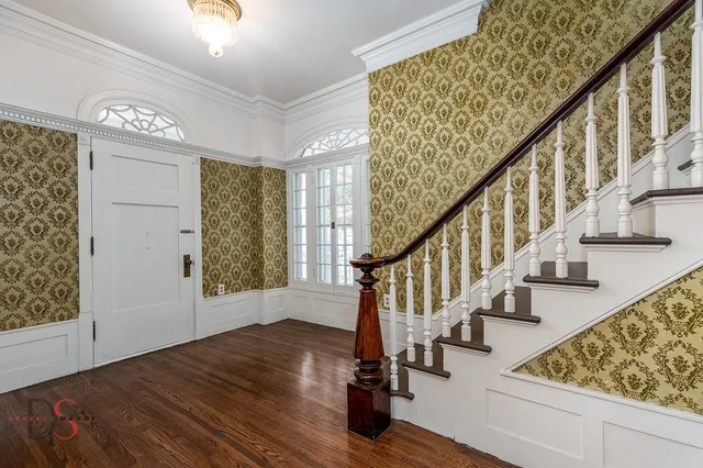 a view of entryway with wooden floor and stairs