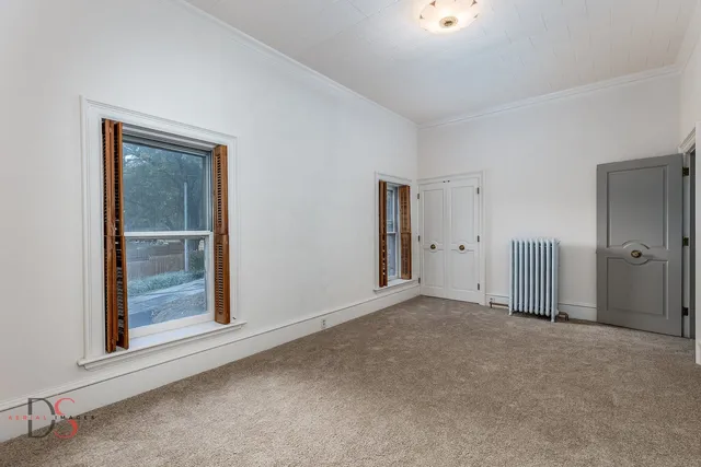 an empty room with closet area