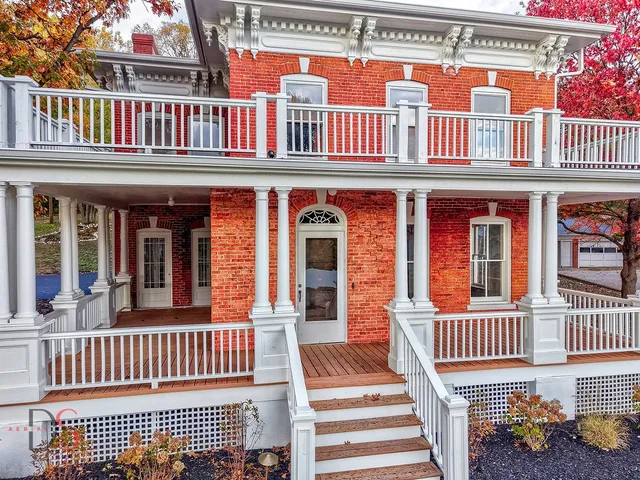 front view of a brick house with a large window