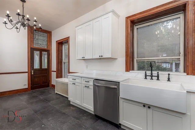 a kitchen with a sink cabinets and window