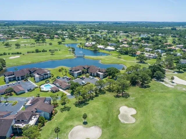 an aerial view of a houses with a lake