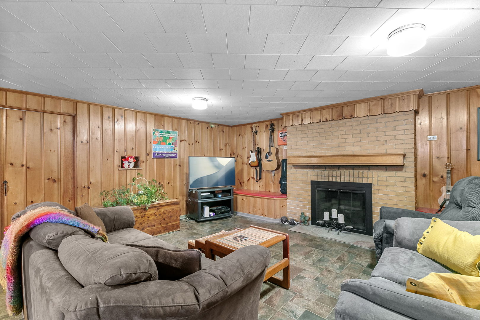 463 Longcommon Road Riverside, IL 60546 - Photo 18 of 36 a living room with furniture a fireplace and a flat screen tv