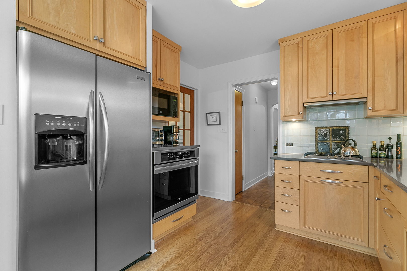 463 Longcommon Road Riverside, IL 60546 - Photo 8 of 36 a kitchen with stainless steel appliances granite countertop a refrigerator and a stove