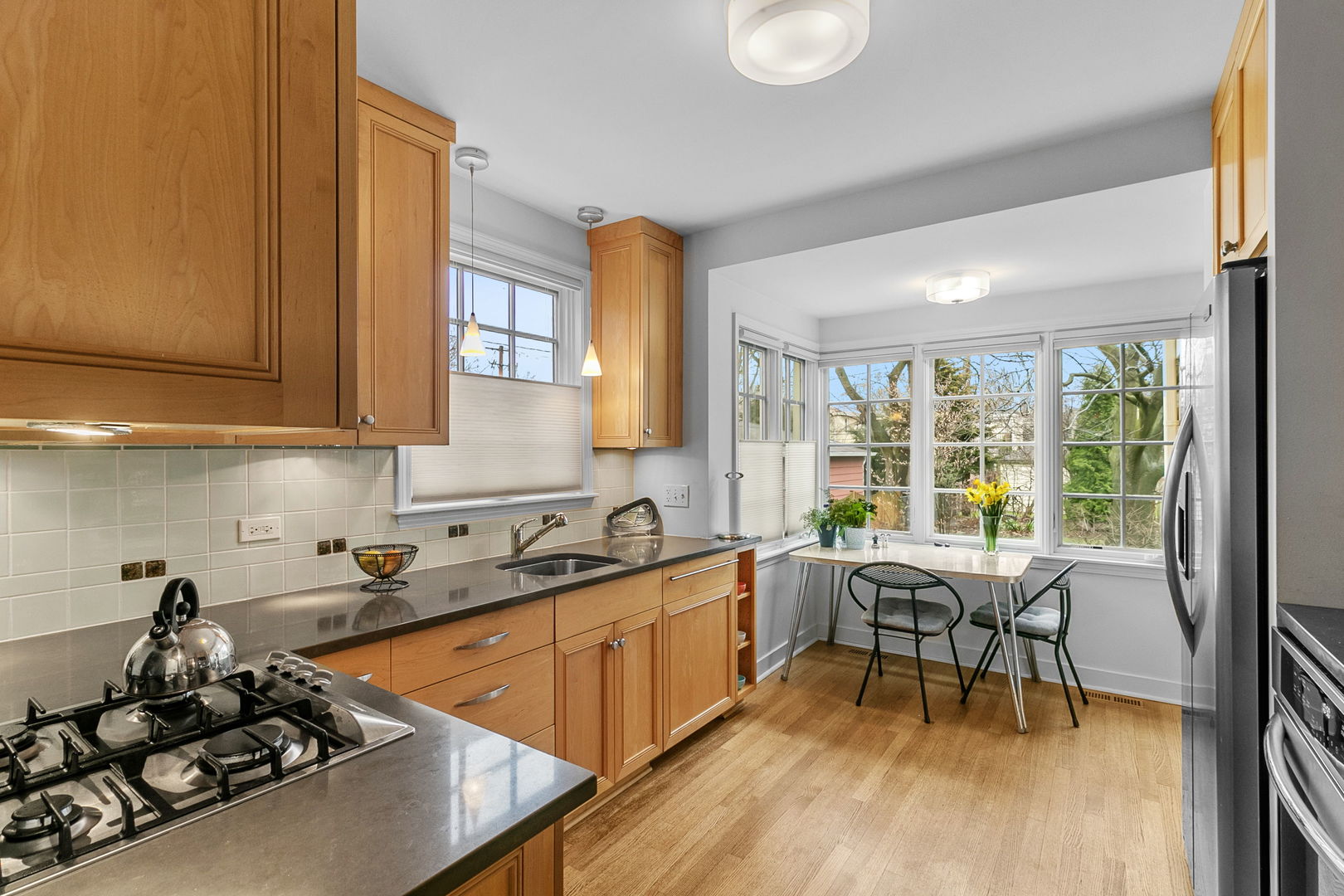 463 Longcommon Road Riverside, IL 60546 - Photo 9 of 36 a kitchen with a sink a table and chairs in it