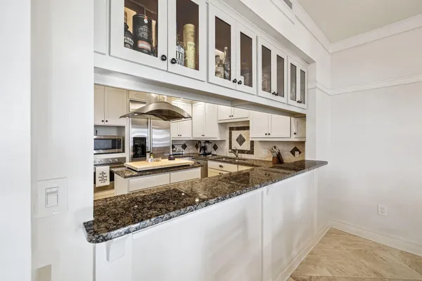 a kitchen with stainless steel appliances granite countertop a stove and a refrigerator
