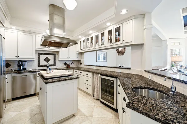 a large kitchen with stainless steel appliances granite countertop a stove and a sink