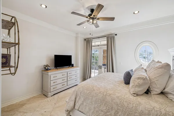 a bedroom with a large bed and a flat screen tv