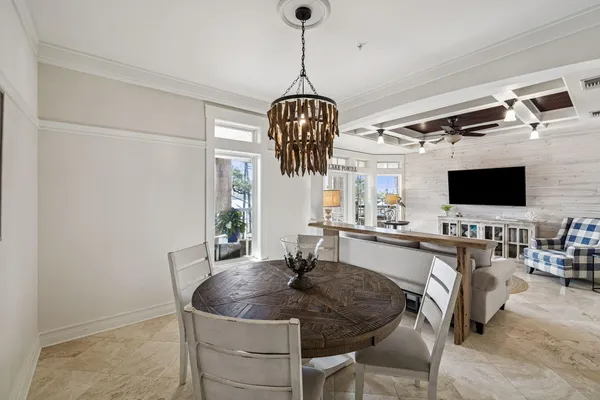 a dining room with furniture and chandelier
