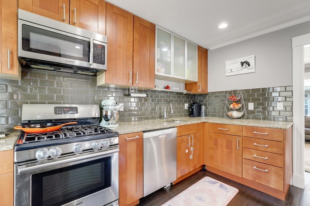 7-9 Goodway Road, Unit 2 Boston, MA 02130 - Photo 12 of 33 a kitchen with stainless steel appliances granite countertop a stove microwave and cabinets